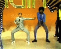 A Group Of People Are Dancing In Front Of A Sign That Says ' Iu ' On It GIF