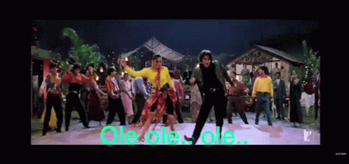 A Group Of People Are Dancing In Front Of A Sign That Says Ole Ole Ole .. GIF
