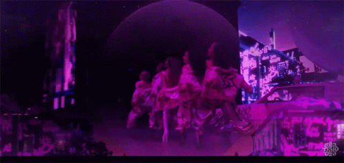 A Group Of People Are Dancing In Front Of A Sign That Says ' Tokyo Pop ' GIF