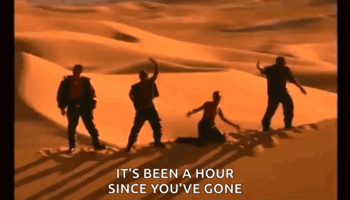 A Group Of People Are Dancing In The Desert While A Woman Is Kneeling Down . GIF