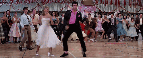 A Group Of People Are Dancing On A Dance Floor In A Gym . GIF