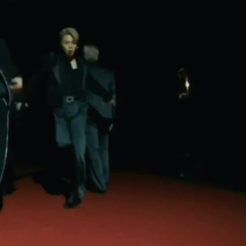 A Group Of People Are Dancing On A Red Carpet GIF