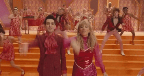 A Group Of People Are Dancing On A Stage And One Of Them Is Wearing A Pink Top GIF