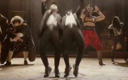 A Group Of People Are Dancing On A Stage In A Theater . GIF