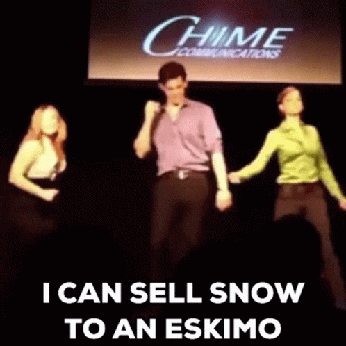 A Group Of People Are Dancing On A Stage In Front Of A Chime Communications Sign . GIF