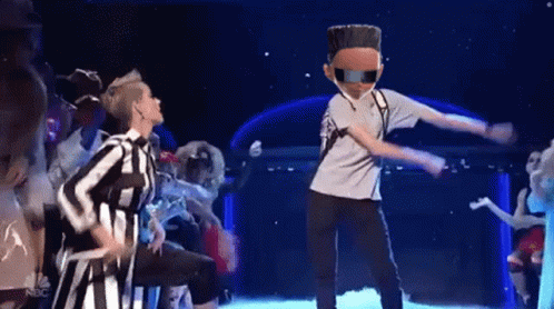 A Group Of People Are Dancing On A Stage With A Nbc Logo In The Background . GIF