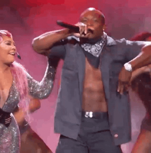 A Group Of People Are Dancing On A Stage With The Number 1 In The Middle GIF