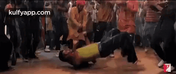 A Group Of People Are Dancing Together In A Club . GIF