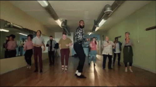 A Group Of People Are Dancing Together In A Room GIF