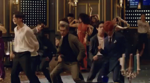 A Group Of People Are Dancing Together On A Dance Floor In A Room . GIF