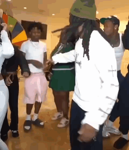 A Group Of People Are Dancing Together On A Dance Floor In A Room . GIF