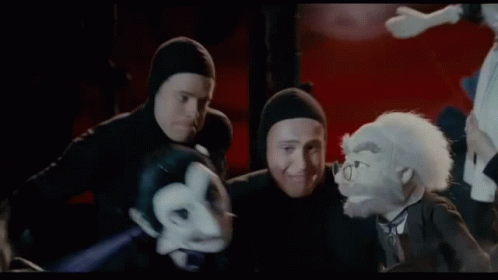 A Group Of People Are Fighting Each Other In A Dark Room . GIF