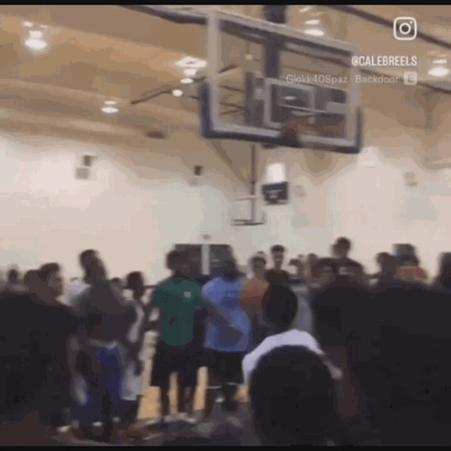 A Group Of People Are Gathered Around A Basketball Hoop With A Caption That Says Calebreels On It GIF