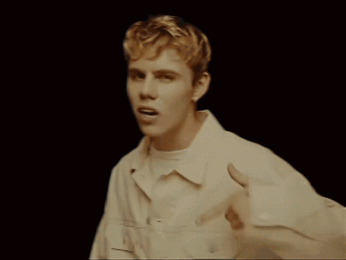 A Group Of People Are Gathered In A Living Room Including A Boy And A Girl GIF