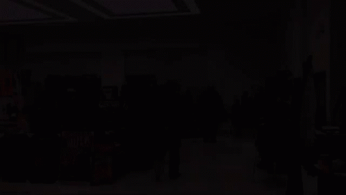 A Group Of People Are Gathered In A Room With Hulk Posters On The Floor GIF