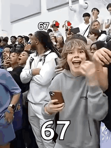 A Group Of People Are Gathered In A Stadium With The Number 67 On The Bottom GIF