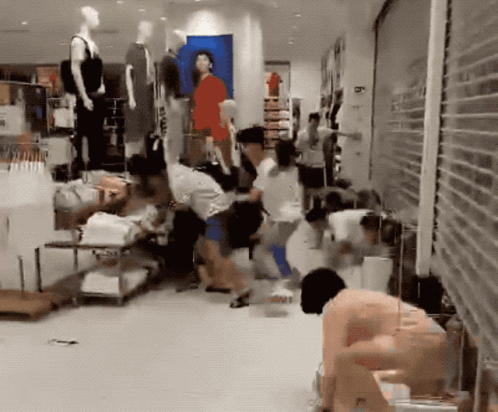 A Group Of People Are Gathered In A Store With A Sign That Says ' A ' On It GIF