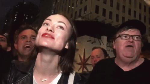 A Group Of People Are Gathered In Front Of A Building That Says Star On It GIF