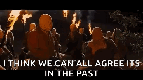 A Group Of People Are Holding Torches In Their Hands And Standing Around A Fire At Night . GIF