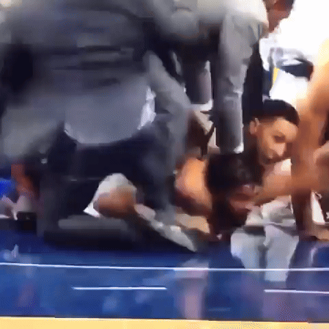 A Group Of People Are Kneeling Down On A Blue Floor GIF