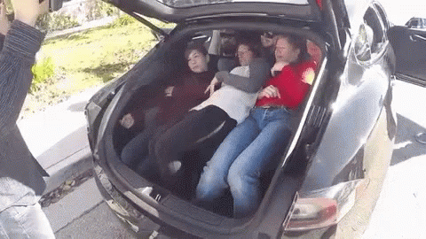 A Group Of People Are Laying In The Back Of A Car GIF