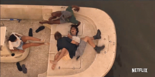 a group of people are laying on a boat with a netflix logo in the corner