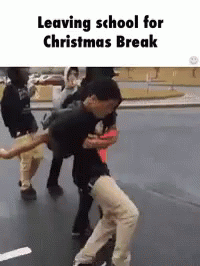 A Group Of People Are Leaving School For Christmas Break And Dancing On The Street . GIF