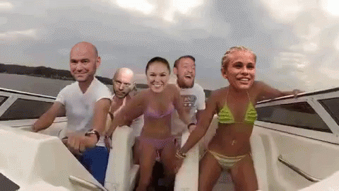 A Group Of People Are On A Boat With Their Faces On The Side . GIF