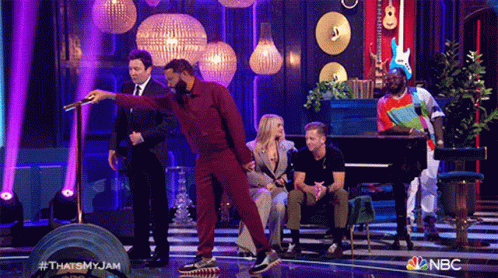 A Group Of People Are On A Stage With A Nbc Logo On The Bottom GIF