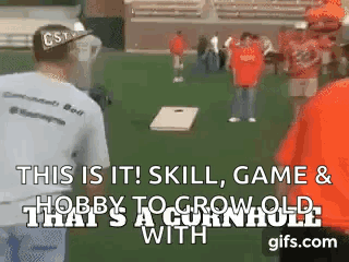 A Group Of People Are Playing A Game Called Cornhole . GIF