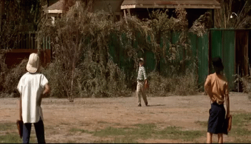 A Group Of People Are Playing Baseball In A Field GIF