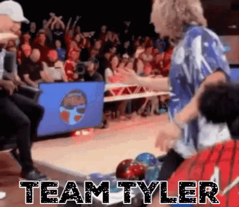 A Group Of People Are Playing Bowling In Front Of A Crowd And The Words Team Tyler Are Written On The Floor . GIF