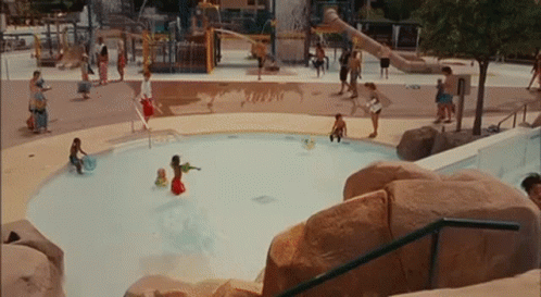 A Group Of People Are Playing In A Pool With The Word Turbo On The Ground GIF