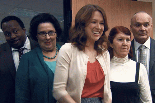 A Group Of People Are Posing For A Picture And One Of The Women Is Smiling GIF