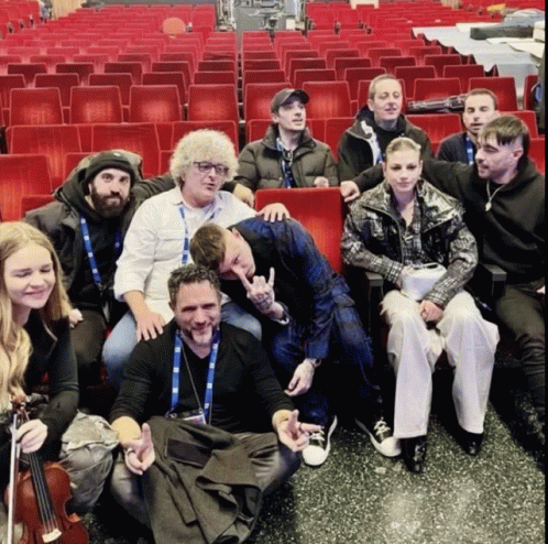A Group Of People Are Posing For A Picture In A Theater GIF