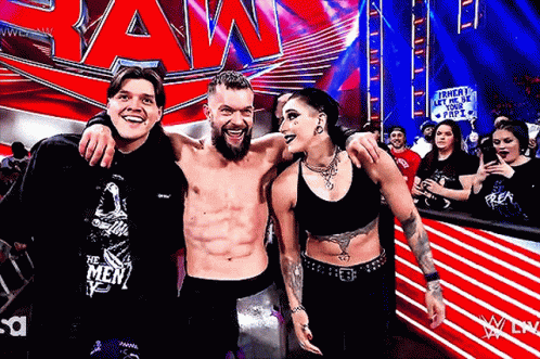 A Group Of People Are Posing For A Picture In Front Of A Sign That Says Raw GIF