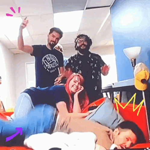 A Group Of People Are Posing For A Picture Together . GIF
