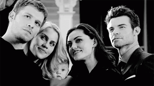 A Group Of People Are Posing For A Picture Together . GIF