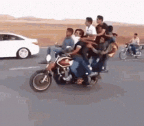 A Group Of People Are Riding A Motorcycle On A Highway . GIF