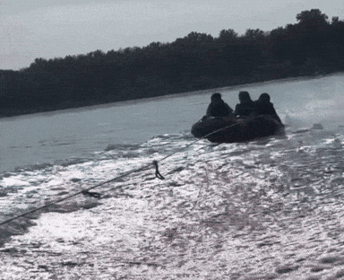 A Group Of People Are Riding A Tube On A Lake GIF