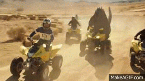 People Riding ATVs In Desert GIF