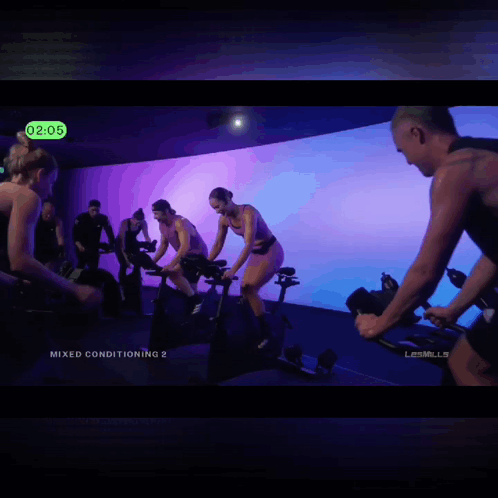 A Group Of People Are Riding Exercise Bikes With The Words Pussycats Or Cheaters At The Bottom GIF