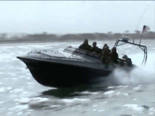 A Group Of People Are Riding In A Boat On A River . GIF