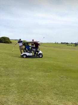 A Group Of People Are Riding In A Golf Cart GIF