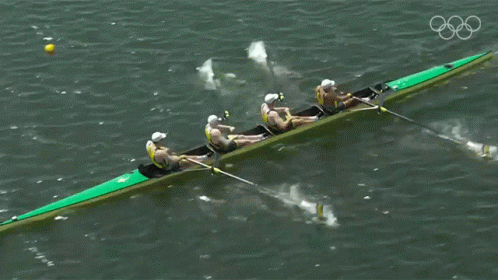 A Group Of People Are Rowing A Boat In The Water GIF