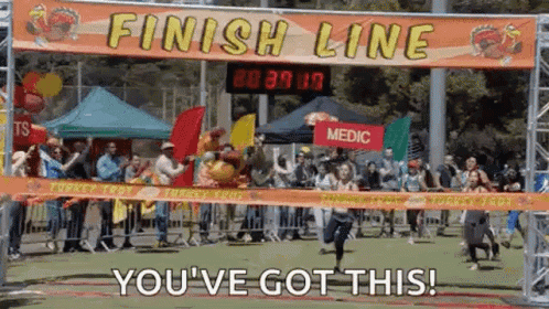A Group Of People Are Running Across A Finish Line With A Sign That Says Finish Line You 'Ve Got This GIF