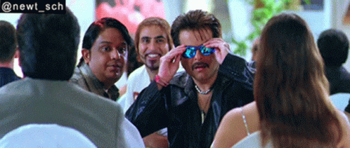 A Group Of People Are Sitting Around A Table And One Of Them Is Wearing Sunglasses And The Hashtag @Newt_sch GIF