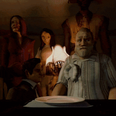 A Group Of People Are Sitting Around A Table With A Plate Of Food GIF