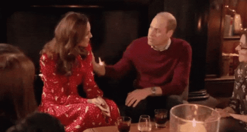A Group Of People Are Sitting Around A Table With Glasses Of Wine And Candles . GIF