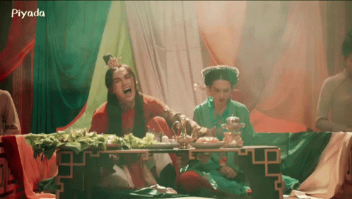 A Group Of People Are Sitting Around A Table With The Word Piyada On The Bottom Right GIF